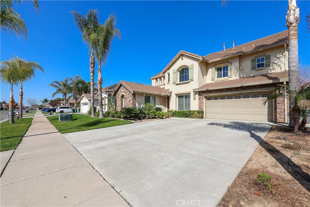 1367 Esplanade Drive Merced, CA 95348 - Photo 2 of 51 a front view of a house with a yard and palm trees