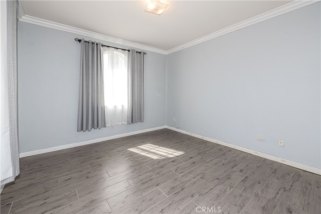 1367 Esplanade Drive Merced, CA 95348 - Photo 26 of 51 an empty room with wooden floor and windows