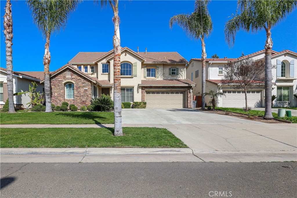1367 Esplanade Drive Merced, CA 95348 - Photo 3 of 51 a view of a white house with a big yard and palm trees