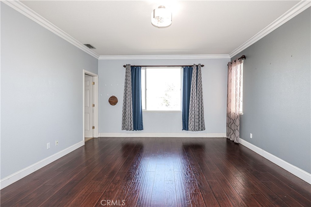 1367 Esplanade Drive Merced, CA 95348 - Photo 32 of 51 an empty room with wooden floor and windows