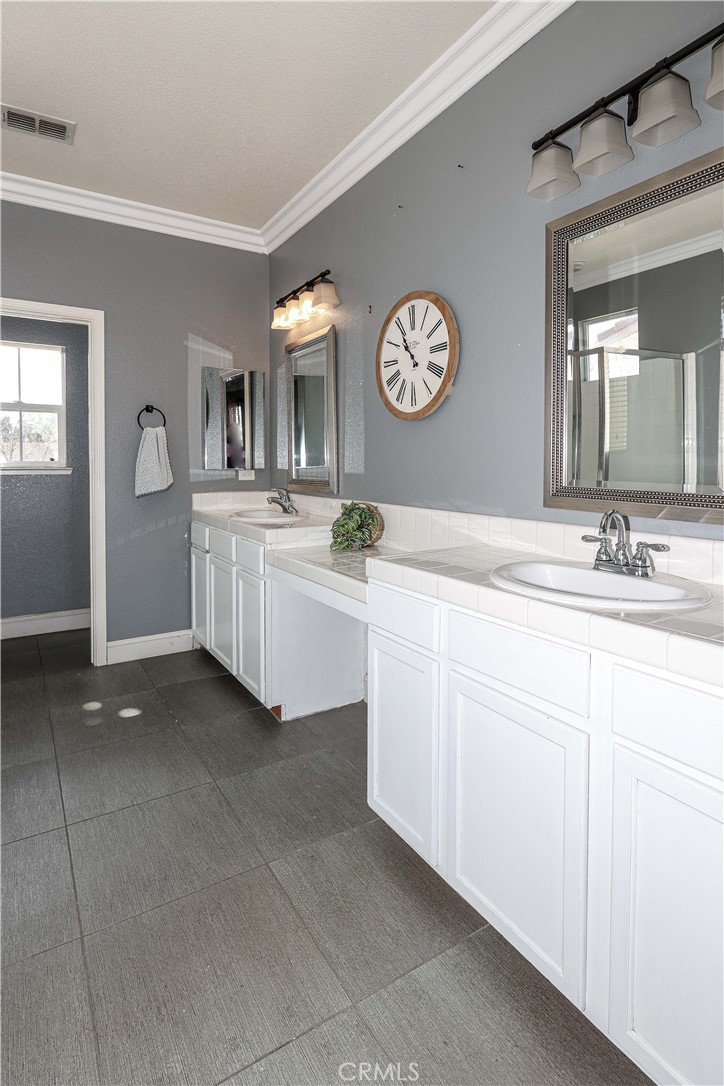 1367 Esplanade Drive Merced, CA 95348 - Photo 34 of 51 a spacious bathroom with a sink and a mirror