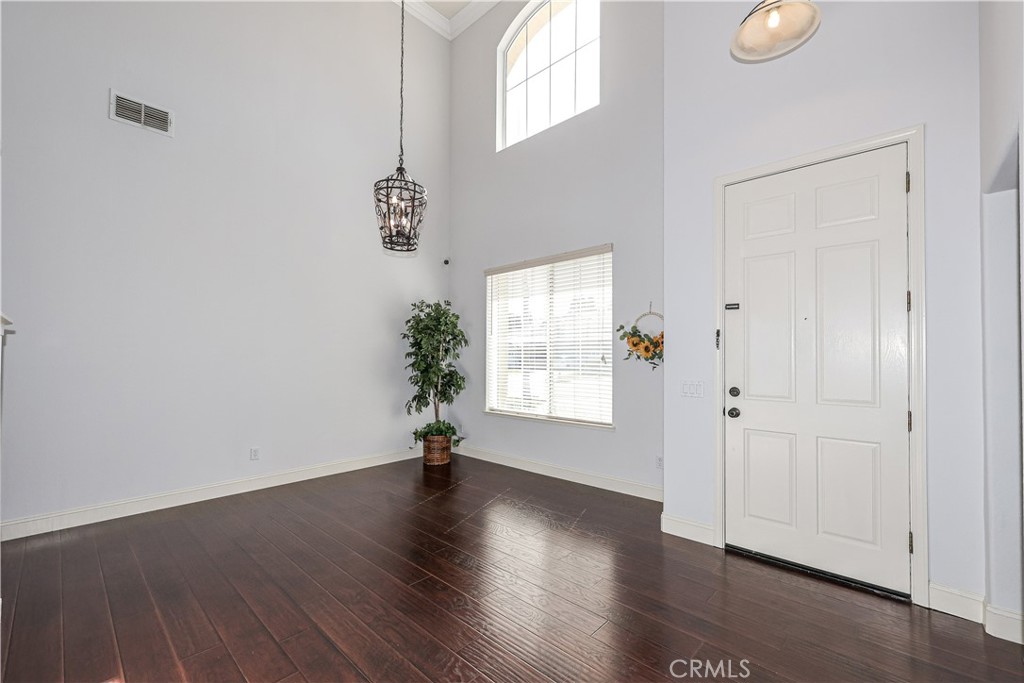1367 Esplanade Drive Merced, CA 95348 - Photo 4 of 51 an empty room with wooden floor and windows