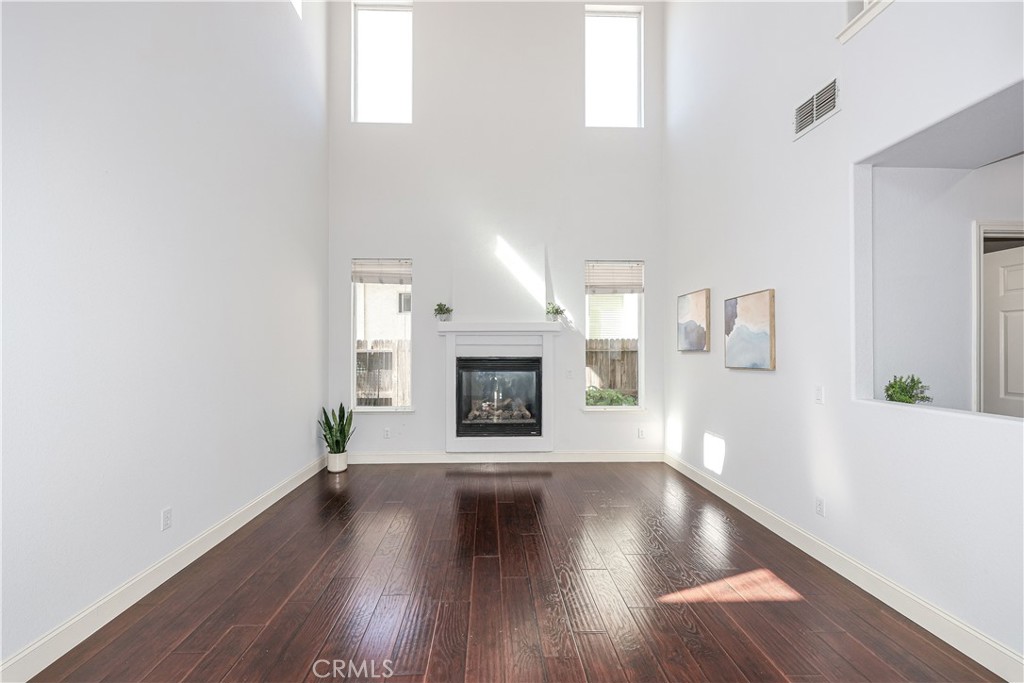 1367 Esplanade Drive Merced, CA 95348 - Photo 7 of 51 a view of an empty room with window and wooden floor