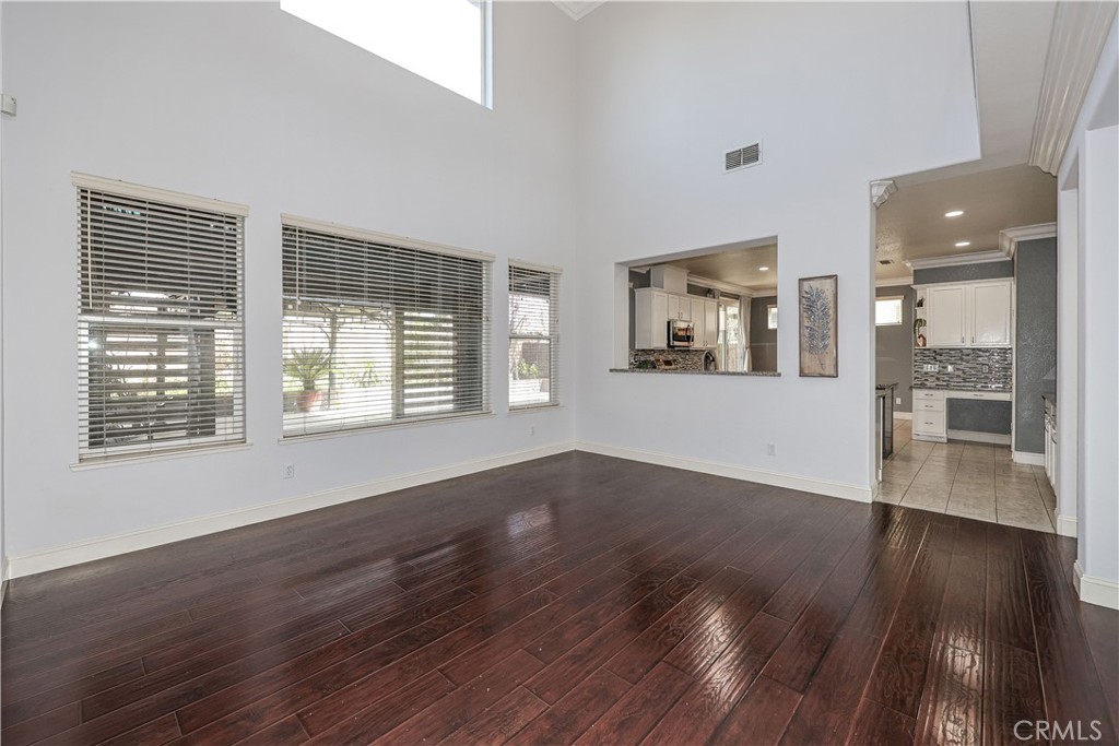 1367 Esplanade Drive Merced, CA 95348 - Photo 9 of 51 an empty room with wooden floor and windows