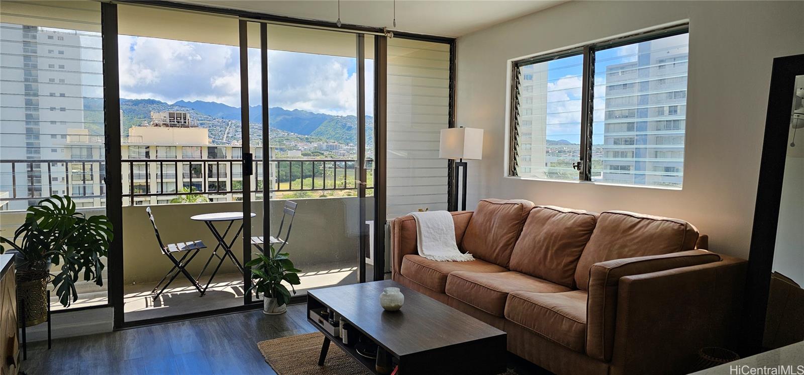 a living room with furniture window and wooden floor