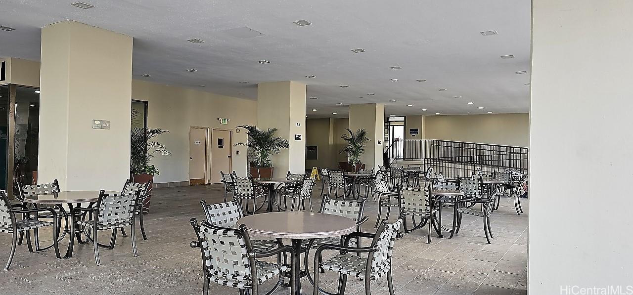 2240 Kūhiō Avenue, Unit 905 Honolulu, HI 96815 - Photo 16 of 18 a view of a a dining room with furniture mirror and fan
