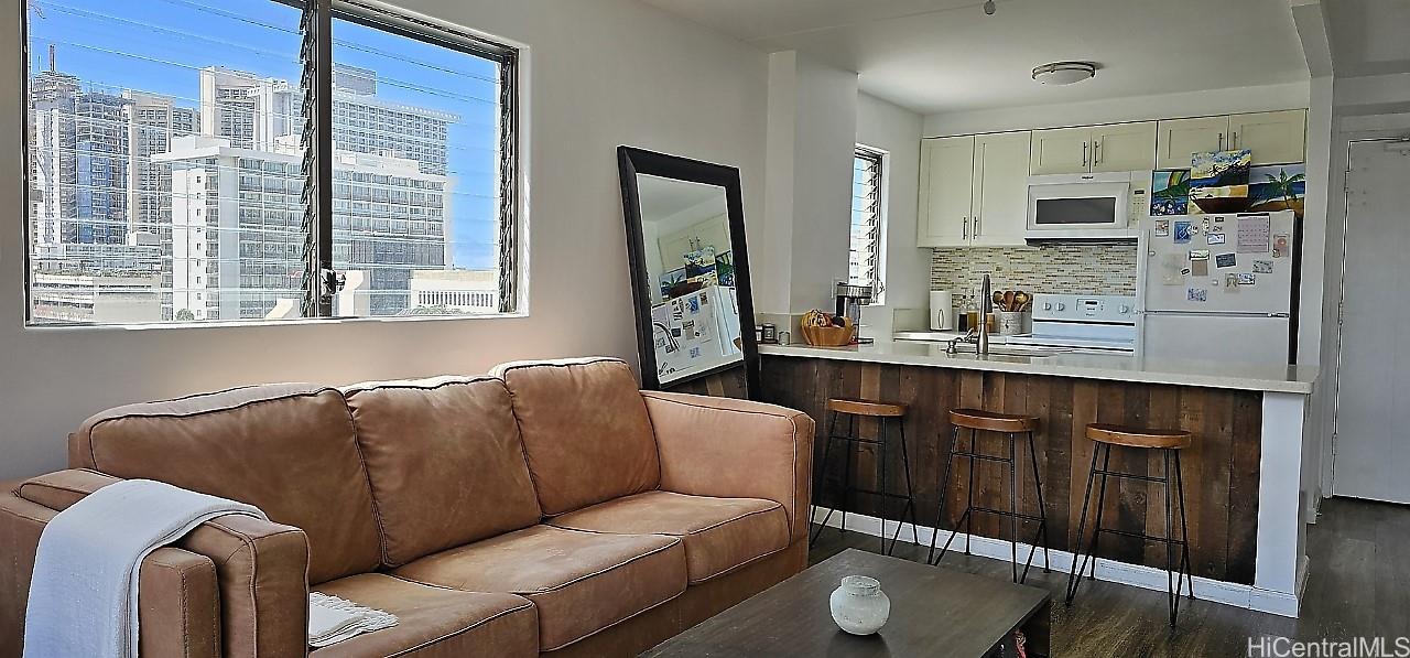 2240 Kūhiō Avenue, Unit 905 Honolulu, HI 96815 - Photo 3 of 18 a living room with furniture a large window and a sink