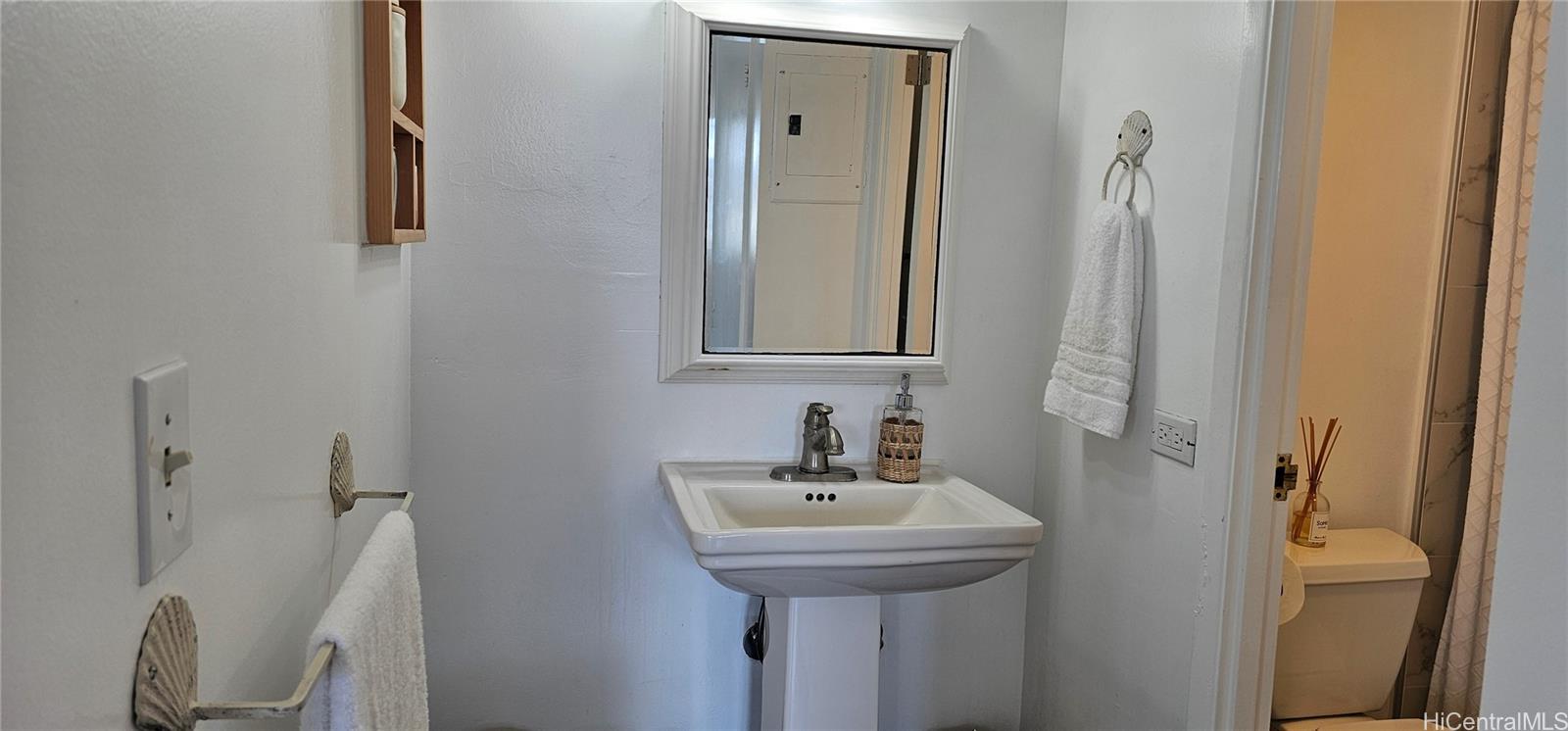 2240 Kūhiō Avenue, Unit 905 Honolulu, HI 96815 - Photo 8 of 18 a bathroom with a sink and mirror