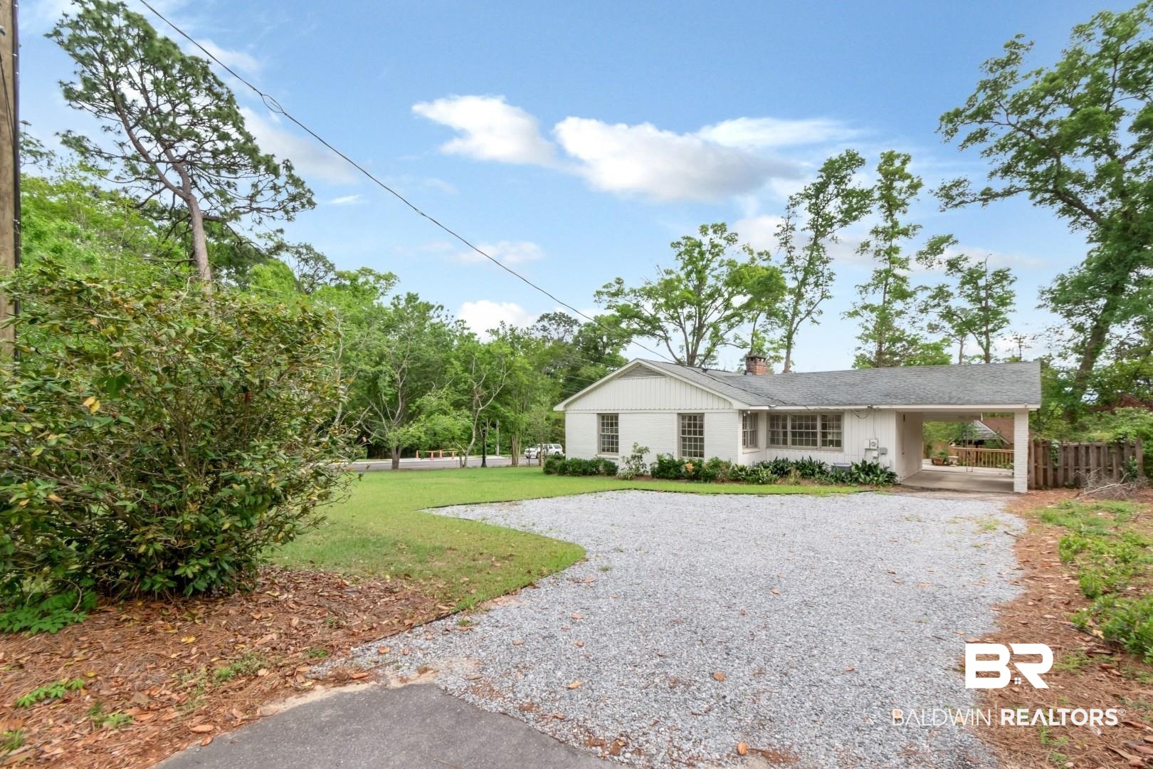 4 Turnout Lane Mobile, AL 36608 - Photo 44 of 53 Ranch-style house with a front yard, gravel driveway, a chimney, and an attached carport