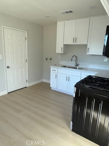 a kitchen with granite countertop stainless steel appliances and wooden cabinets