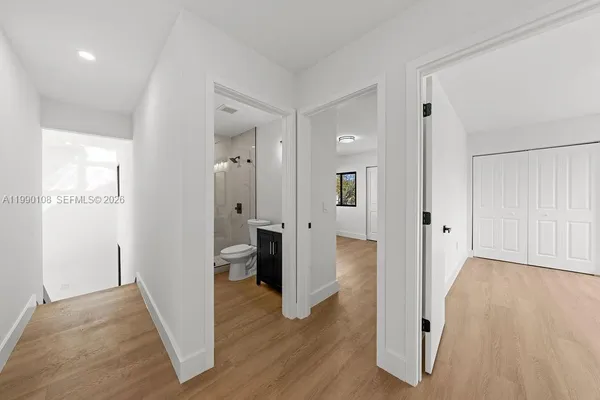 a view of staircase with railing and white walls