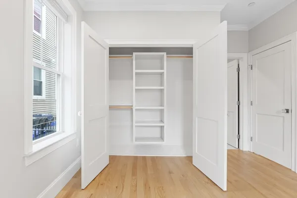 a view of a room with wooden floor and windows