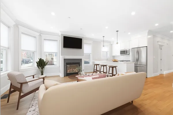 a living room with furniture a fireplace and a flat screen tv