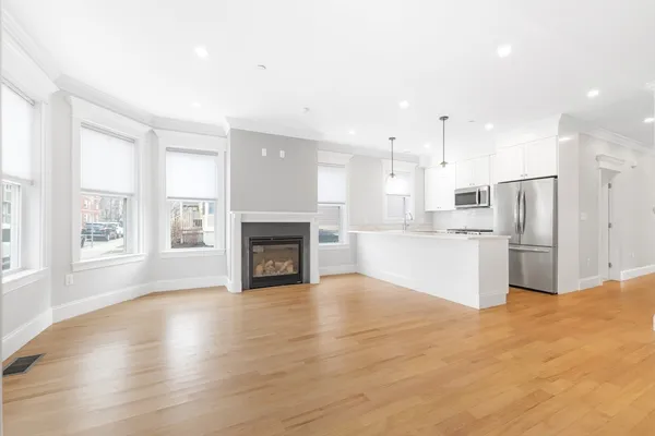 a view of kitchen with granite countertop cabinets and refrigerator