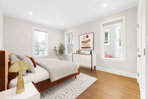 a bedroom with a bed and wooden floor
