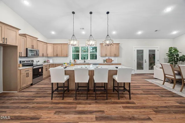 a living room with furniture and a chandelier
