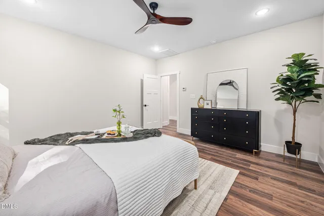 a bedroom with a bed and wooden floor