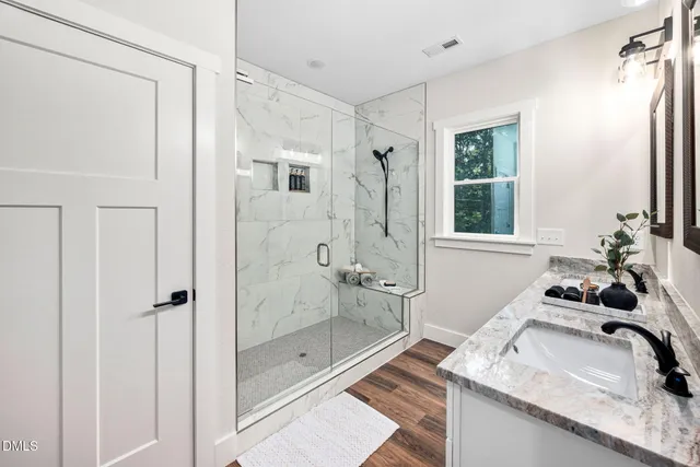 a bedroom with a bed and a potted plant