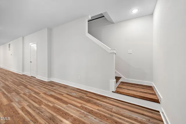 a view of a room with wooden floor and bathroom