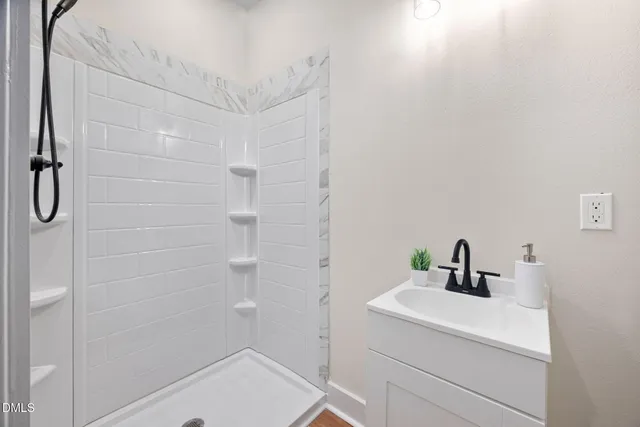 a view of empty room with wooden floor