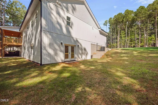 a view of an house with backyard and tree