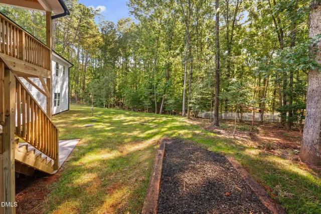 a view of yard with tree and wooden fence
