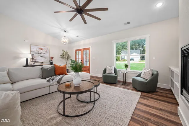 a living room with furniture a fireplace and a large window
