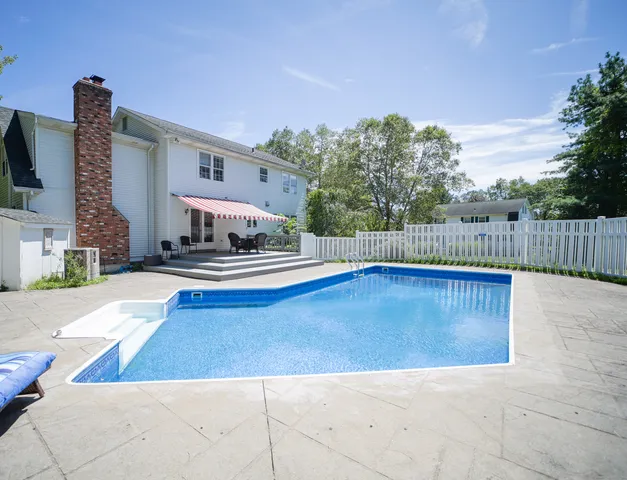 a swimming pool with wooden fence
