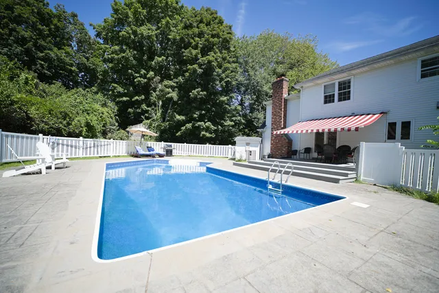swimming pool view with a seating space
