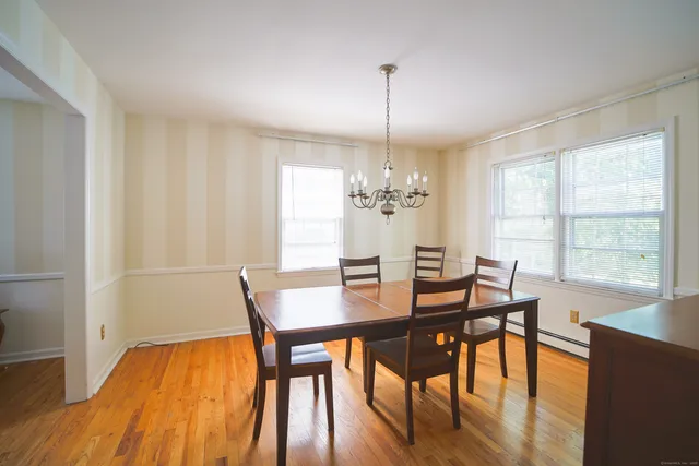a view of a dining room with furniture window and wooden floor