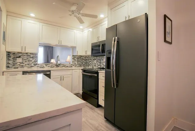 a kitchen with stainless steel appliances a refrigerator sink and stove
