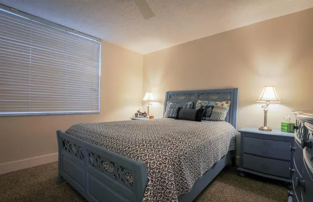 a bedroom with a bed and a night stand