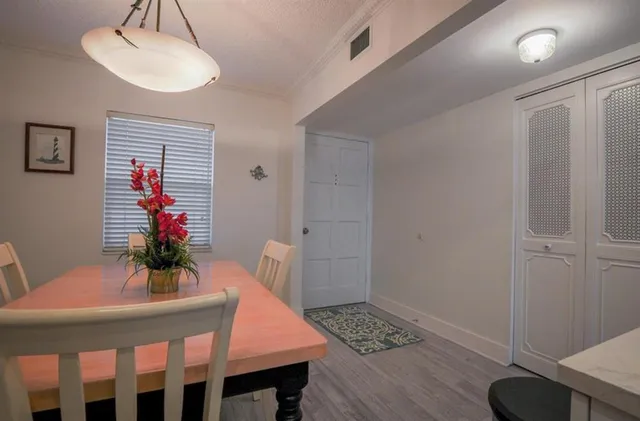 a dining room with furniture and wooden floor