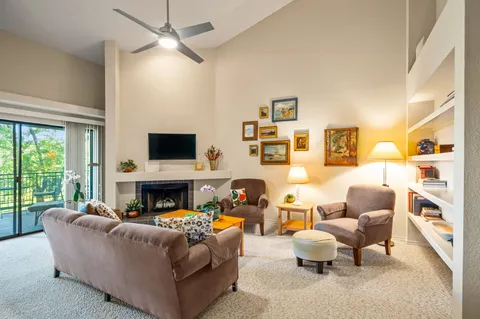 a living room with furniture fireplace and a flat screen tv
