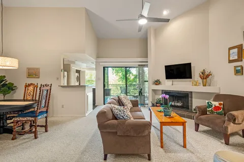 a living room with furniture fireplace and a flat screen tv