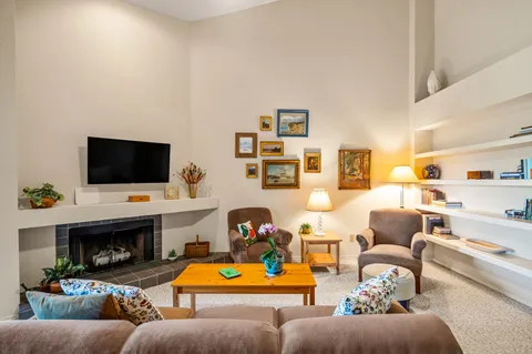 a living room with furniture and kitchen view