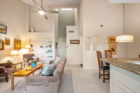 a kitchen with kitchen island granite countertop a sink stainless steel appliances and a window