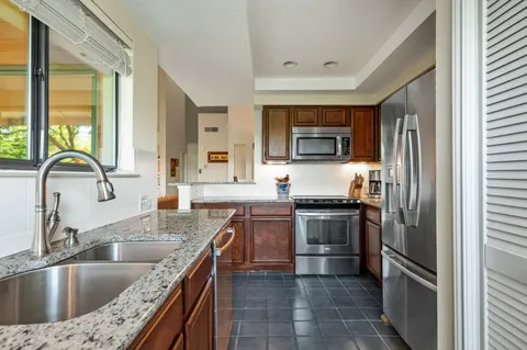 a kitchen with refrigerator and cabinets