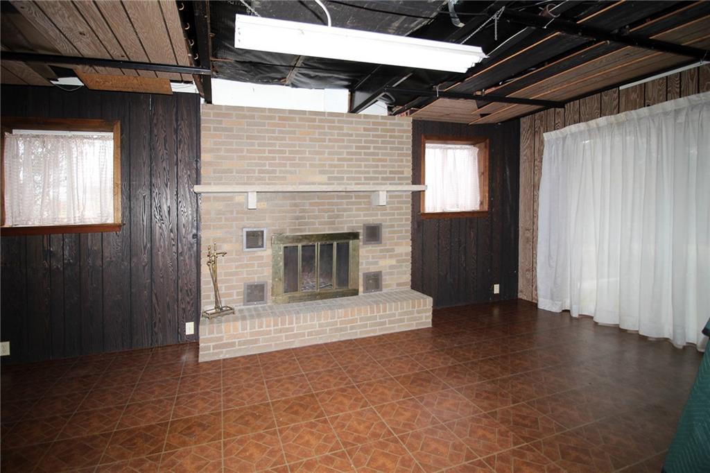 478 Cecil-Henderson Road Cecil, PA 15321 - Photo 22 of 28 a view of an empty room with wooden floor and a fireplace
