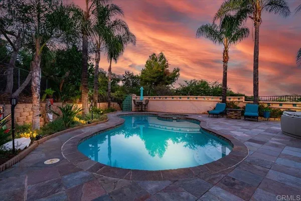 swimming pool view with a garden space