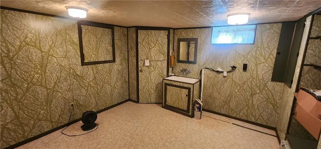 a view of a hallway with wooden walls