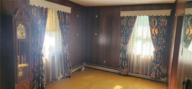 a view of an entryway with wooden floor and door