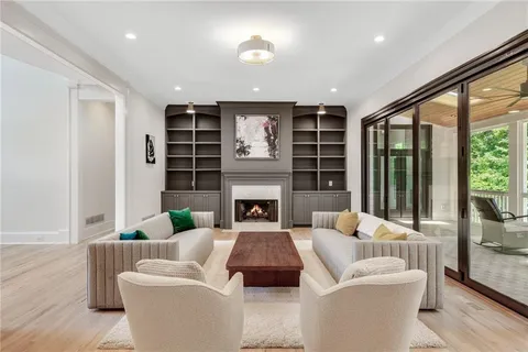 a living room with furniture and large windows