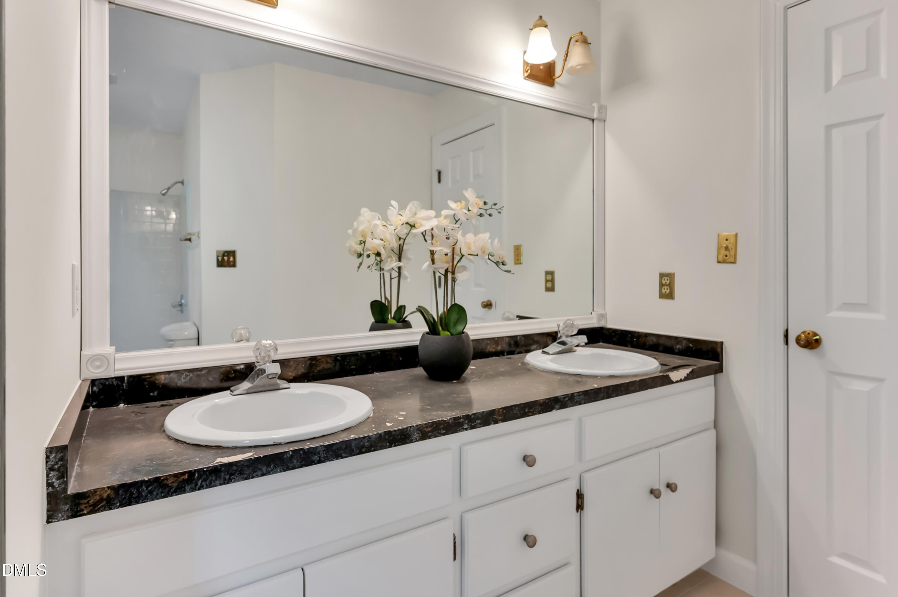 7500 Drayton Court Raleigh, NC 27615 - Photo 14 of 27 a bathroom with a granite countertop sink and a mirror