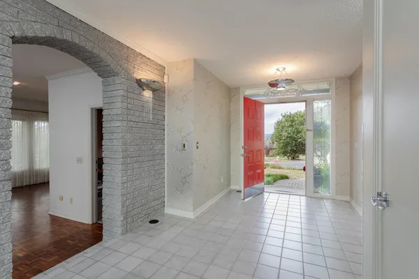 a dining room with furniture entryway and wooden floor