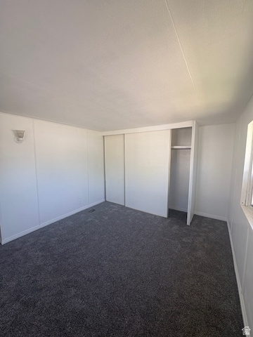 1111 North 2000 West, Unit 293 Farr West, UT 84404 - Photo 6 of 13 Spacious room featuring new gray carpeting and white panel walls