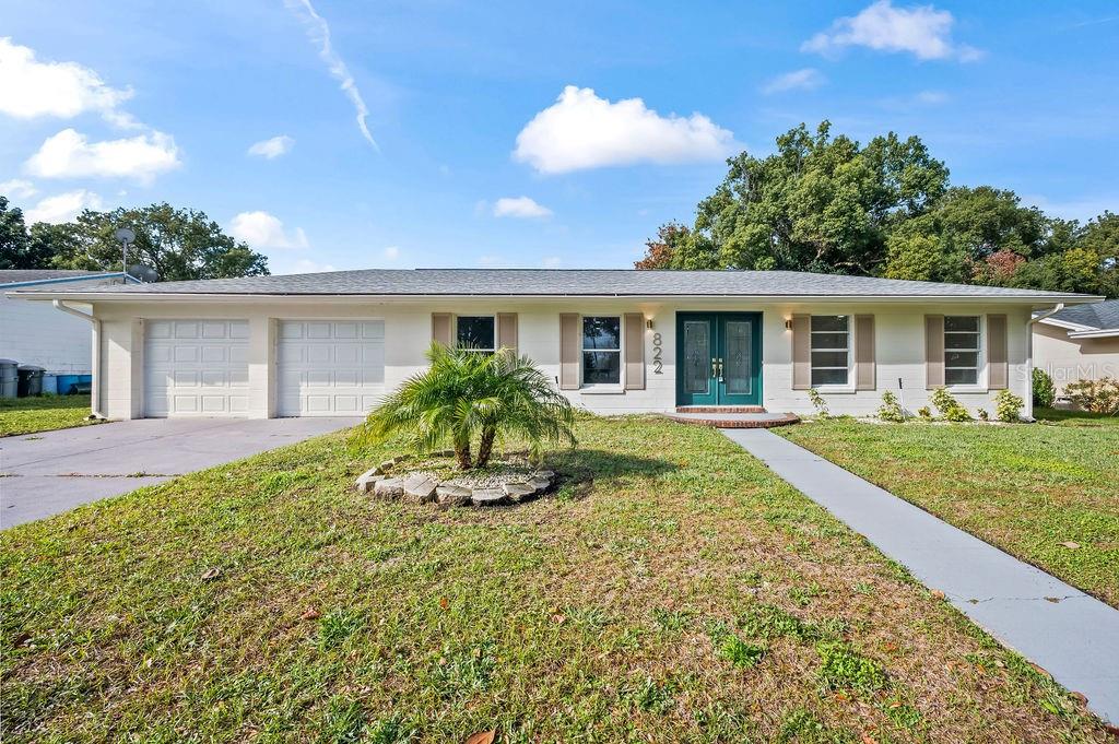 a view of house with backyard and garden
