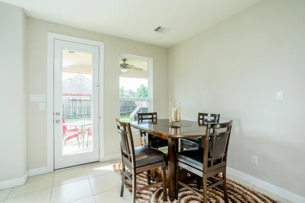 a view of a dining room with furniture and a window