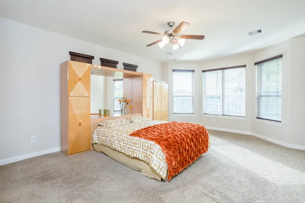 a bedroom with a bed and a chandelier