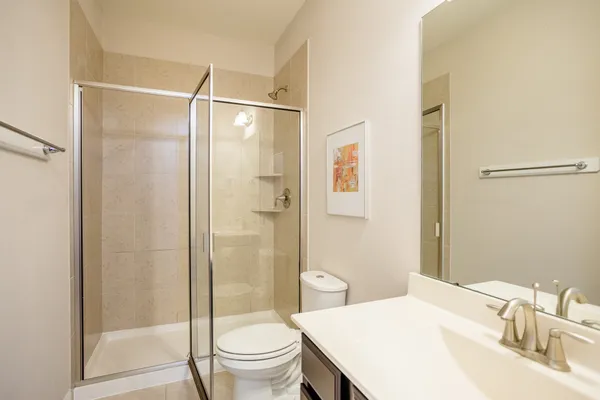 a bathroom with a sink toilet and shower